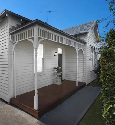 Front of white weatherboard house.